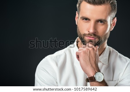 portrait of handsome pensive businessman in white shirt, isolated on black