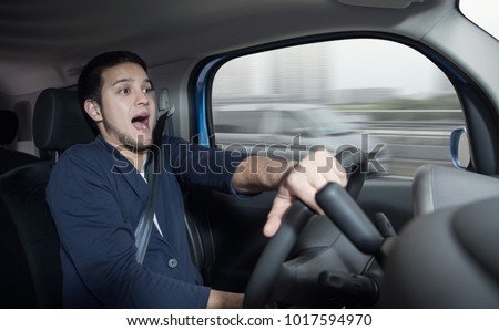 Surprised driver in the car.?Car accident. Abrupt steering. Royalty-Free Stock Photo #1017594970