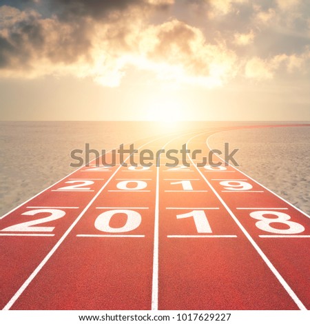2018 into future on running track in sunset desert landscape Royalty-Free Stock Photo #1017629227