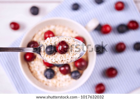 Porridge with fruit on spoon 
