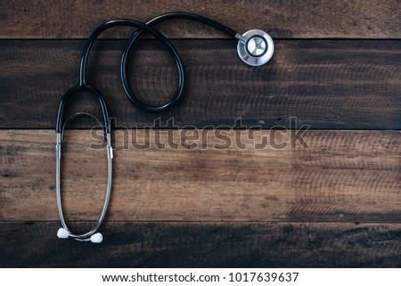 Stethoscope on wooden table background. medical health concept