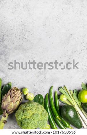 Variety of green vegetables and fruits copyspace on gray