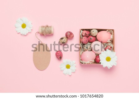 Easter eggs on pink background. Top view. Copyspace. Background with easter eggs. Pink eggs with flowers. Easter photo concept. Easter gifts.
