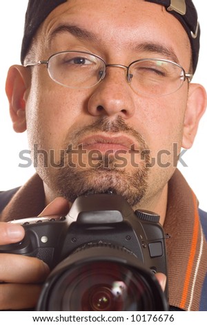 Young man with digital camera taking picture