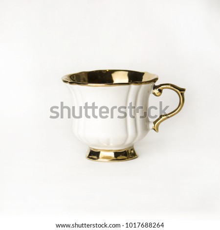 White tea cup with a gold handle