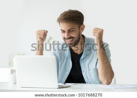 Happy excited man celebrating online win success achievement result looking at laptop screen, successful entrepreneur excited by good news in email, motivated by business win or new job opportunity Royalty-Free Stock Photo #1017688270