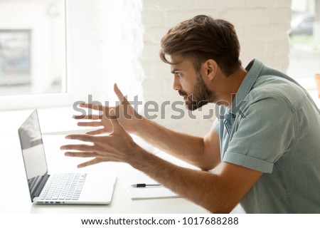 Furious man angry about bad news online or pc software failure, mad helpless office worker having problem with broken laptop, stressed student hates computer crash, user indignant about data loss Royalty-Free Stock Photo #1017688288