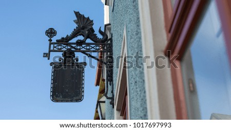empty signboard in the Gothic style, on the street of the Austrian city, day/night