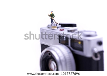 Miniature people : Cleaning personnel  with Retro, old, vintage and classic film camera.