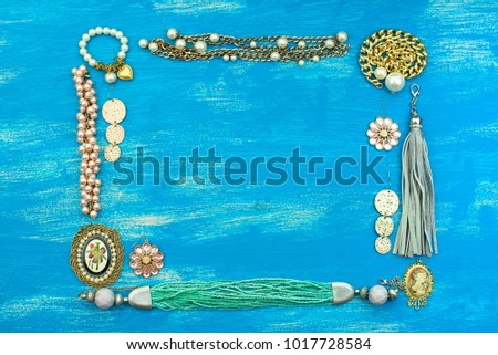 Decorative background for text. Empty picture frame jewelry on a painted wooden background. Top view Flat lay