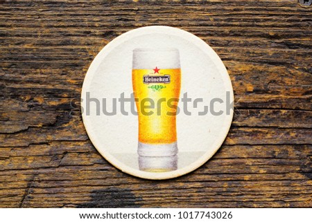 AMSTERDAM, HOLLAND - April 2, 2017.: Beer mats from Heineken Lager Beer in vintage background , it was first brewed by Gerard Adriaan Heineken in 1873 Royalty-Free Stock Photo #1017743026