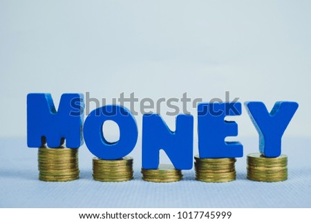 Text MONEY and stack of coin with copy space for add text, motivational business and financial concept idea.