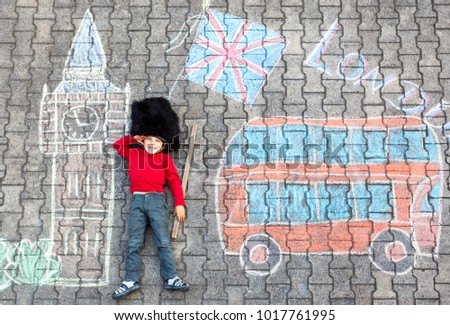 kid boy in british soldier uniform with London chalks picture