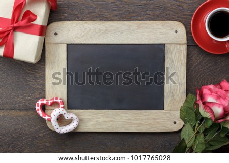 Table top view aerial image of decoration valentine's day background concept.Flat lay arrangement of blank space blackboard & essential items on modern rustic brown wood for mock up creative design