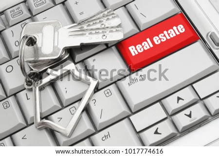 Real estate online service concept with laptop keyboard and keys