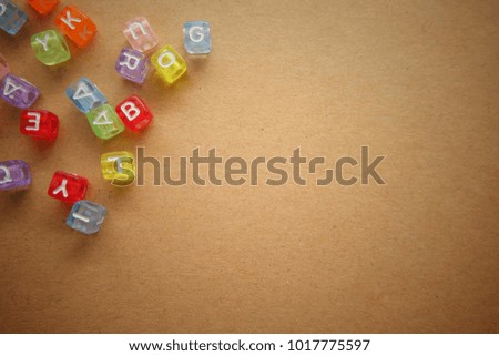 Colorful English alphabet on brown background.