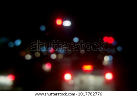 Bokeh lights from traffic jam at night, blurred background