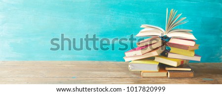 Opened Book on a pile of old books, panorma, good copy space Royalty-Free Stock Photo #1017820999