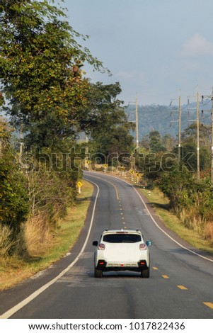 White car driving on the road.Transportation in high-country or Mountain area, Dangerous curve .
