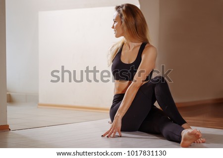 Yoga at home. Woman stretching seated spinal twist. Young slim girl makes exercise