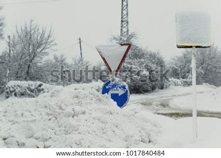 Road signs in winter drifted into the snowdrifts.