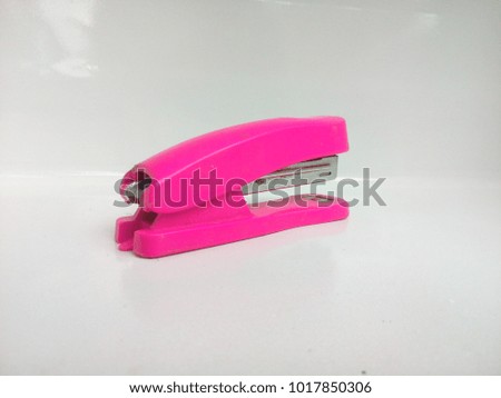 Pink staples on a white background