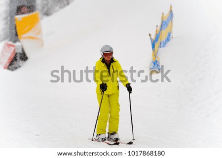 BUKOVEL, UKRAINE - FEB 4, 2018: Unidentified woman does skiing in Bukovel, the largest ski resort in Eastern Europe