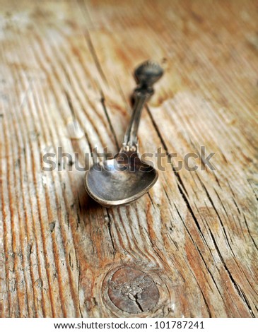 Old styled spoon on old retro wooden background, old retro vintage style photography