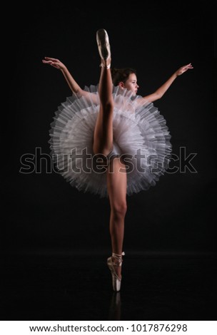 A young ballerina in a ballet tutu and on pointe
