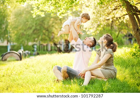 happy young family spending time outdoor on a summer day Royalty-Free Stock Photo #101792287