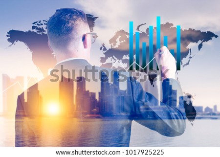 Businessman writing data graph with world map on city and buildings in background. Management financial concept