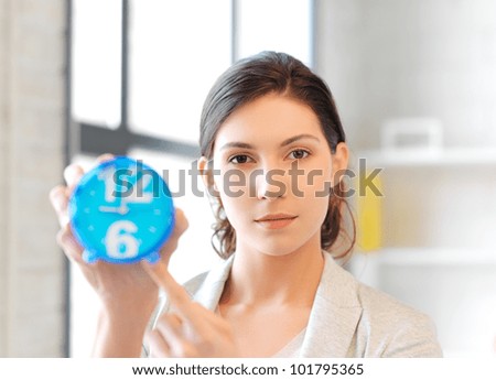 bright picture of attractive businesswoman with clock