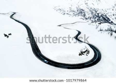 Aerial view of a car traversing Bernina Pass in the Swiss Alps