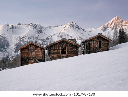 Tradition Swiss wooden cabins are seen high in the Swiss Alps near Zermatt, Switzerland during sunset