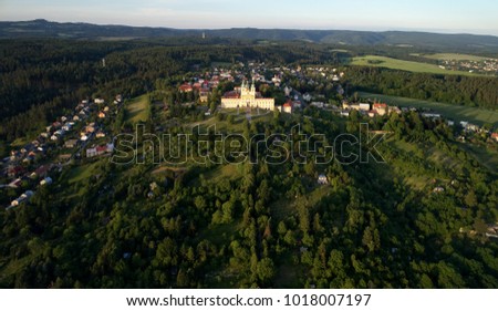 Aerial view on Pilgrimage Church of the Visitation of the Virgin Mary - pilgrimage site of European significance "The Holy Hill", from-afar visible silhouette of basilica minor lit by setting sun.
