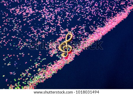 Abstract shiny musical note on blue background