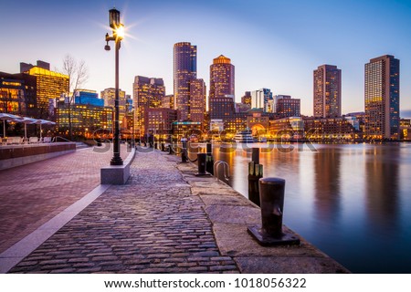 The architecture of Boston in Massachusetts, USA at night with its mix of contemporary and historic buildings at Boston Harbor and Financial District.