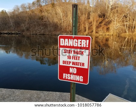 danger stay back deep water no fishing sign near water