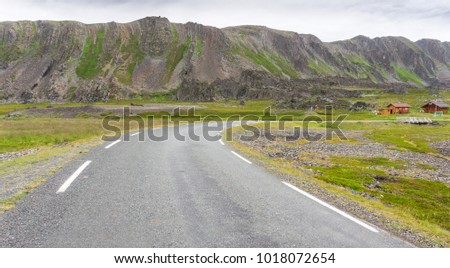 Rocky cliffs along the Varanger National Tourist Route on the coast of the Barents Sea, Finnmark, Norway Royalty-Free Stock Photo #1018072654