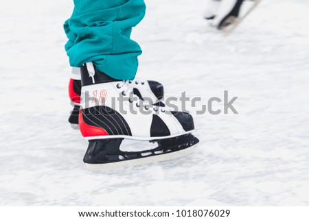 winter fun. A man is riding a new skate on a natural open-air skating rink
