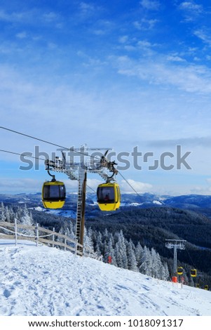 Cable car at the Belchen in winter. Belchen in the Black Forest  in the state Baden-Wuerttemberg. In the background the snow covered mountain Feldberg region. Upright format