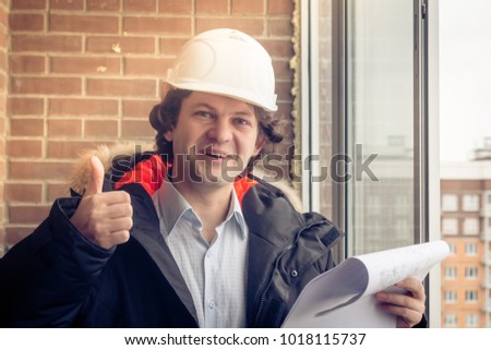 Happy Caucasian Construction Worker Giving Thumb Up. Soft focus, toned.