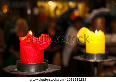 candles fire on a background of blurry people