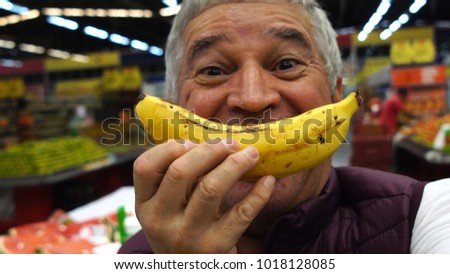 Senior Man Smiling With Banana