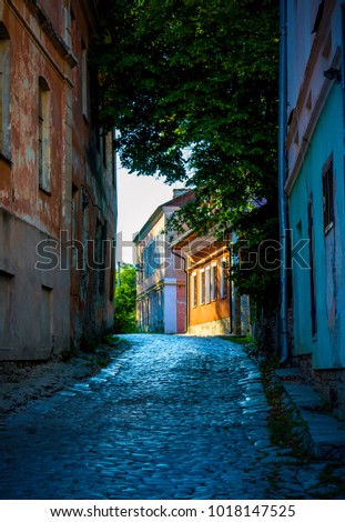 Photo of old ancient stone road between the buildings in Kamyanets-Podilsky