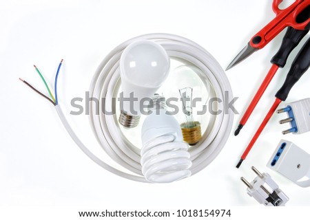 Close-up of work tools and components for a residential electrical installation, photographed on a white background.
