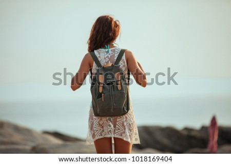 Rear view of a woman standing on the beach