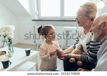 Young girl talking with her grandparents