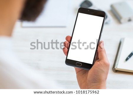 Closeup photo businessman holding hand credit card and using smartphone. Online payments plastic card. Horizontal mockup. Blurred, film effect Royalty-Free Stock Photo #1018175962