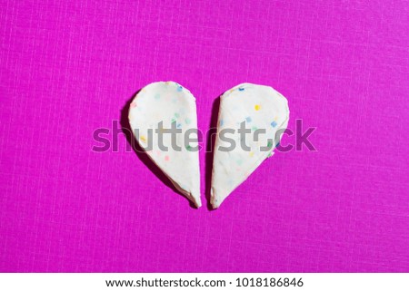 Multi-colors broken heart made with plasticine on pink background